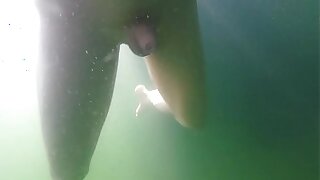 Pierced guy is swimming naked and plays a bit with his tiny shaved cock